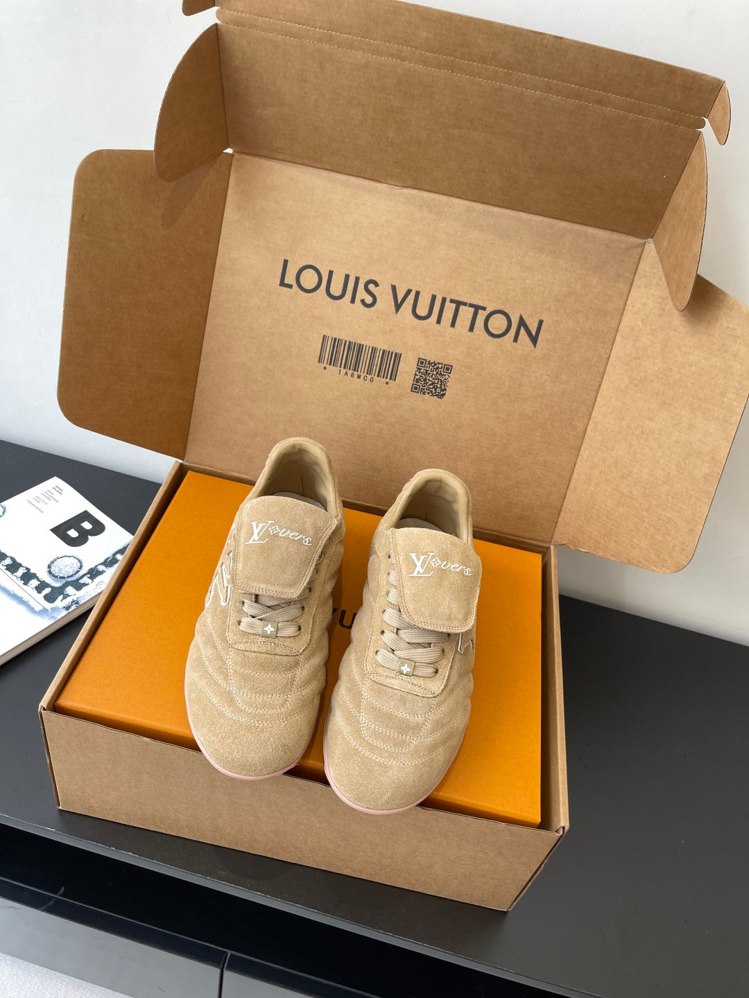 Beige Louis Vuitton women’s sneakers in box, paired shoes with lace-up front