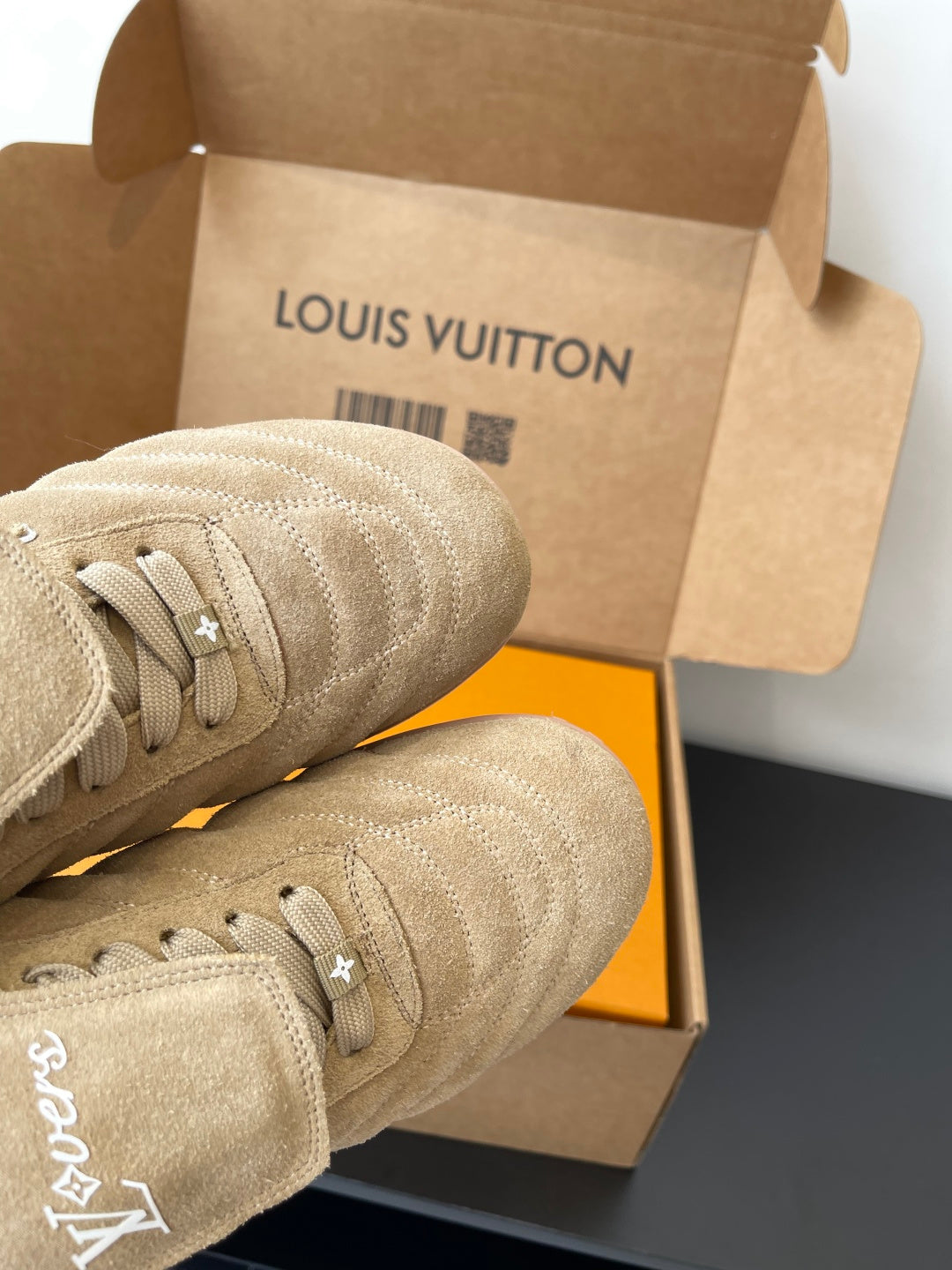 Beige Louis Vuitton women’s sneaker toe and laces, textured knit upper