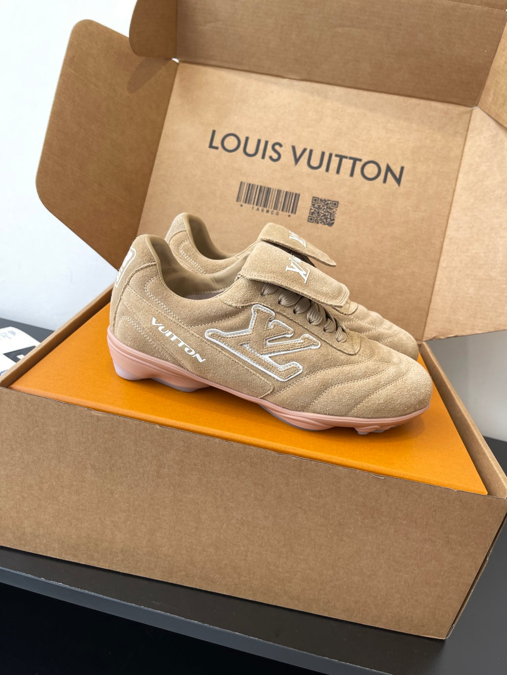 Beige Louis Vuitton women’s sneaker with lace-up design and side LV detail