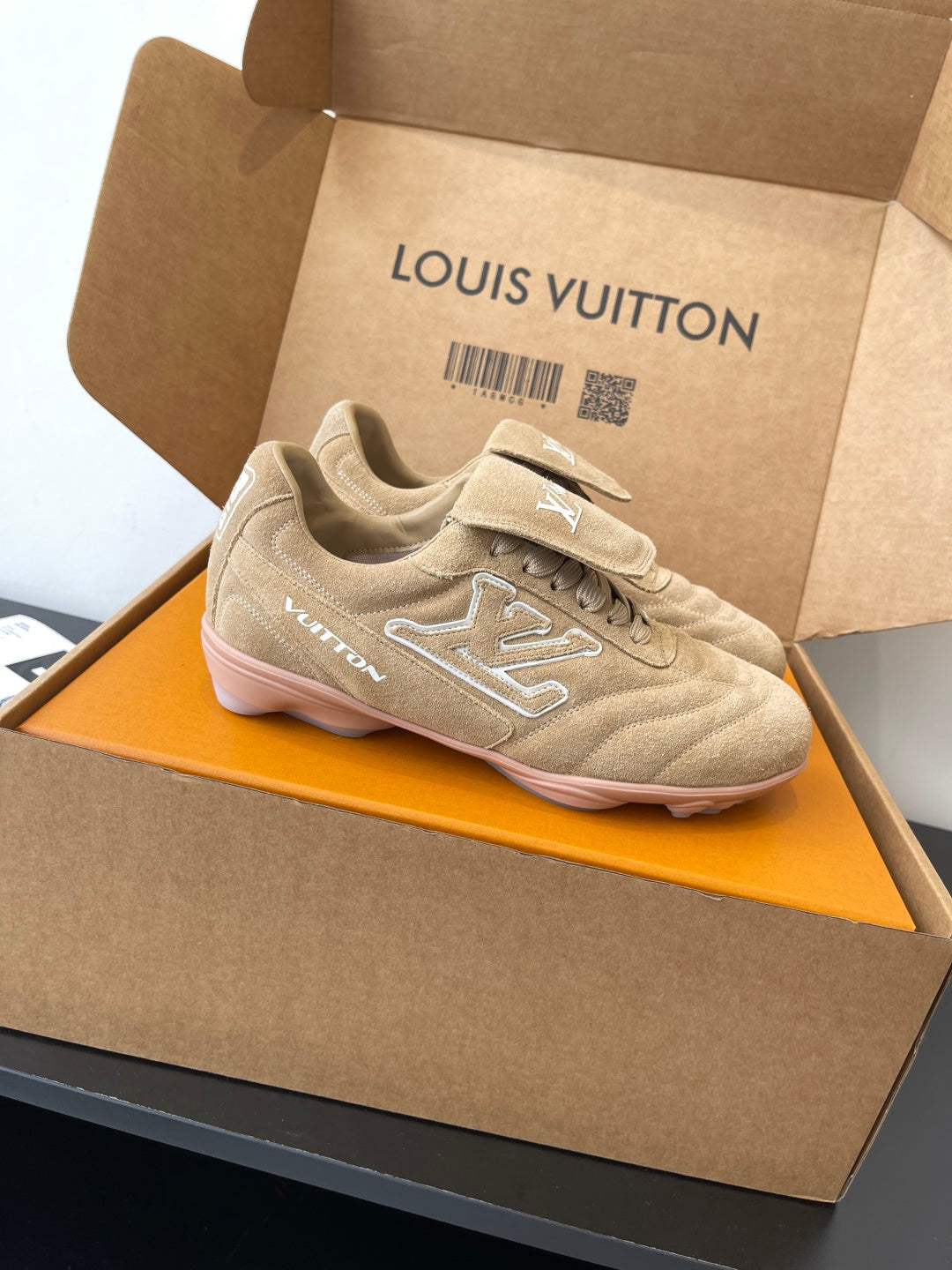 Beige Louis Vuitton women’s sneaker with lace-up design and side LV detail