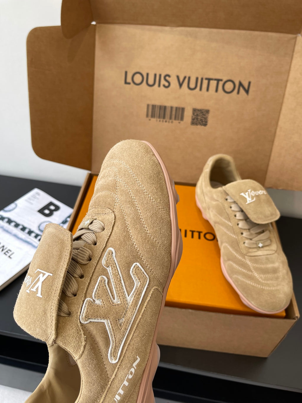 Beige Louis Vuitton women’s sneakers, one close-up showing star-shaped LV embroidery