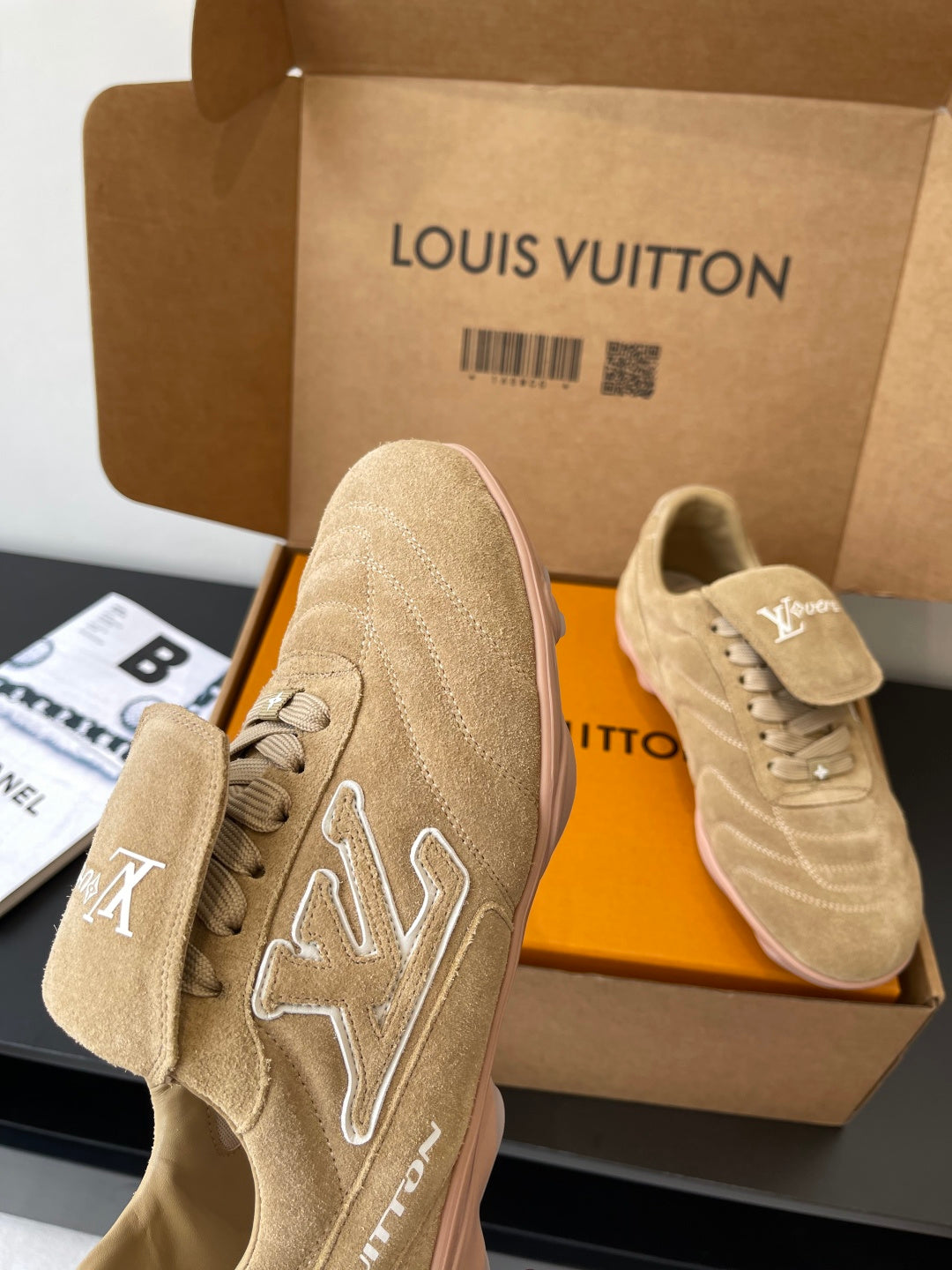 Beige Louis Vuitton women’s sneakers, one close-up showing star-shaped LV embroidery