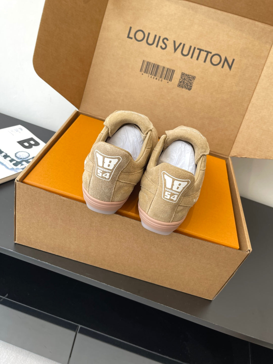 Beige Louis Vuitton women’s sneakers back view, heel patches with LV monogram