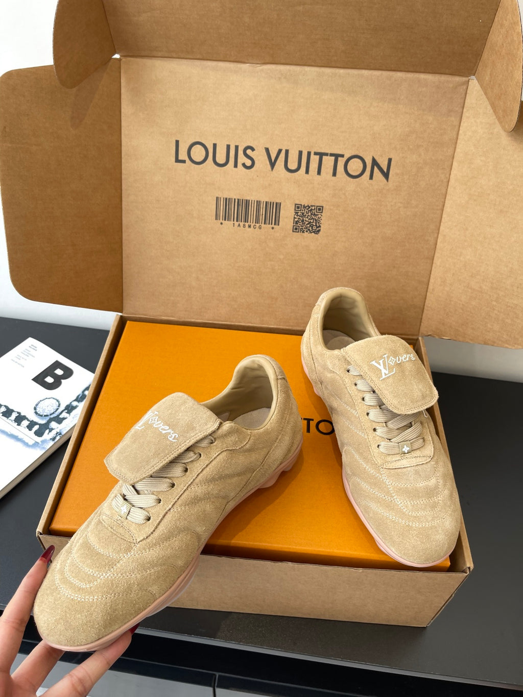 Beige Louis Vuitton women’s sneakers, two pairs side-by-side in presentation box