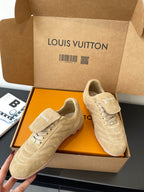 Beige Louis Vuitton women’s sneakers, two pairs side-by-side in presentation box