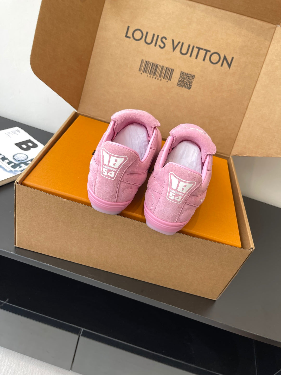 Louis Vuitton women's pink sneakers in box, back view of heels