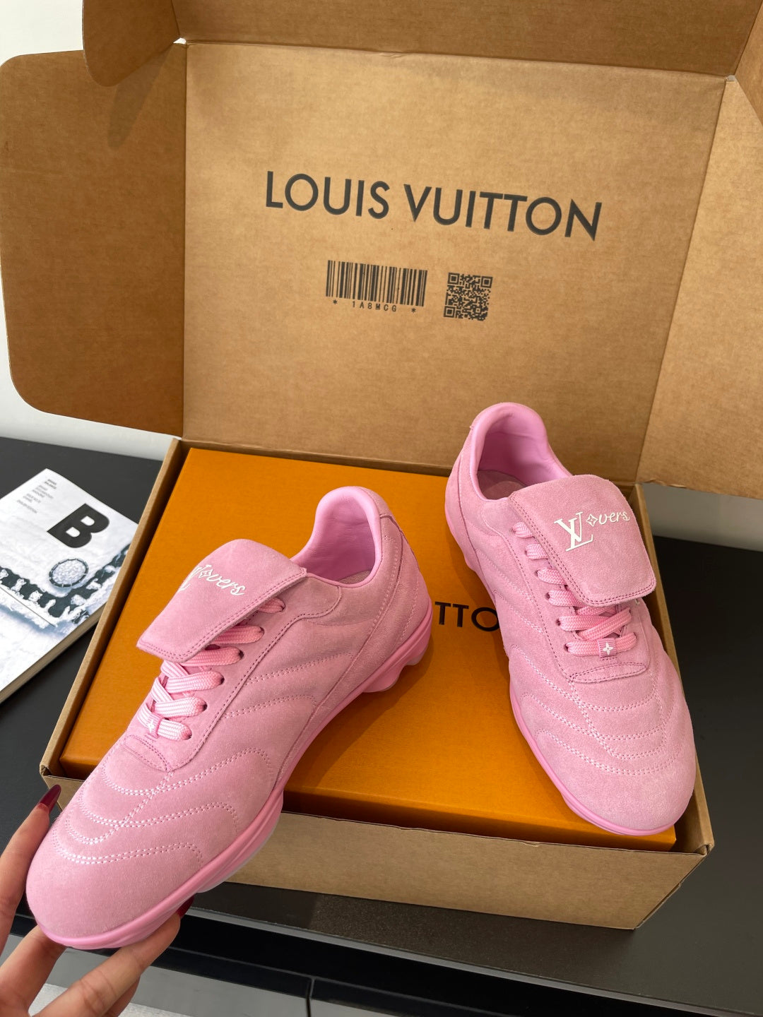 Louis Vuitton women's pink sneakers pair in box, three-quarter angle