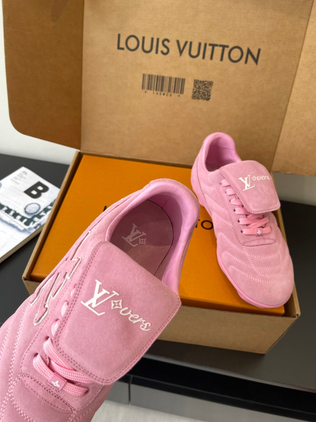 Louis Vuitton women's pink sneakers in box, close-up of toe and heel