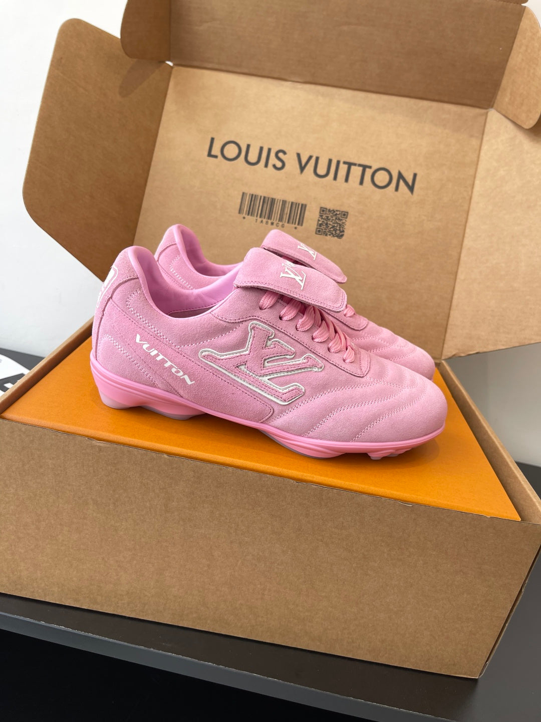 Louis Vuitton women's pink lace-up sneakers on orange insert, side view