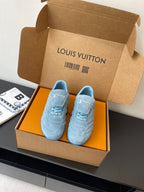Light blue lace-up sneakers with Louis Vuitton logo, shown in open gift box
