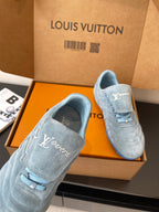 Light blue suede sneakers with Louis Vuitton logo, front close-up in open box