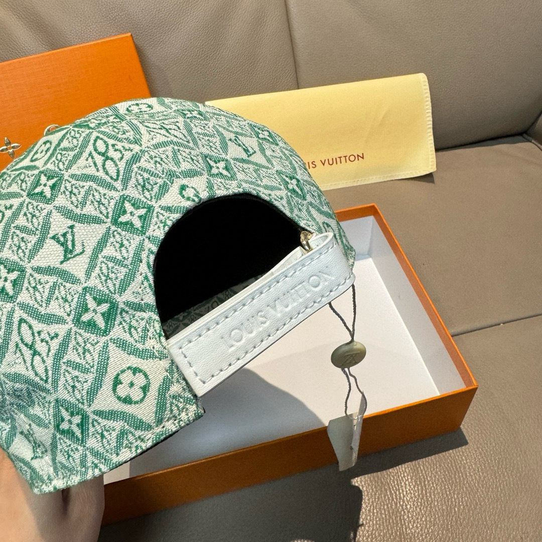 Louis Vuitton cap side detail with green monogram fabric and white strap patch