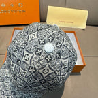 Monogram-pattern baseball cap in dark gray/black with round top button detail.