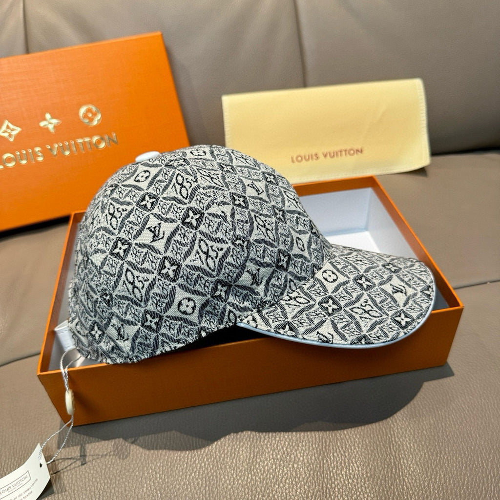 Monogram-pattern baseball cap in dark gray/black with curved brim, front-and-side view.