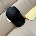 Louis Vuitton dark baseball cap with snap-button crown and stitched paneling.