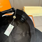 Louis Vuitton dark cap interior with fabric strap, hang tag, and logo patch.