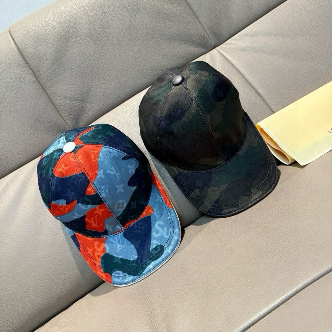 Two baseball caps side by side: dark green and dark blue orange logo prints