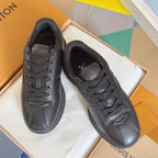 Black leather lace-up sneakers pair, front toe and lace detail visible