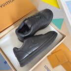 Black leather lace-up sneakers, pair shown on display with embossed logo