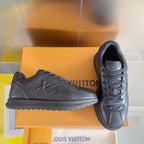 Black leather low-top sneakers with lace-up front and embossed side logo detail