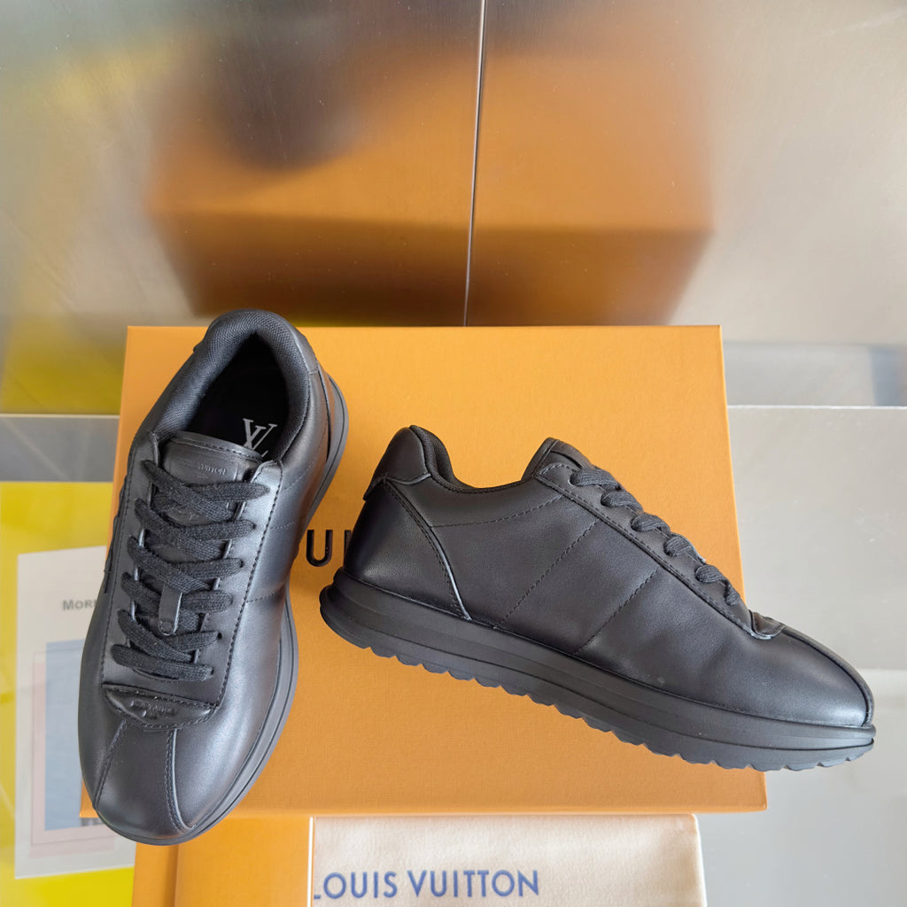 Black leather lace-up sneakers, one side profile and front quarter view