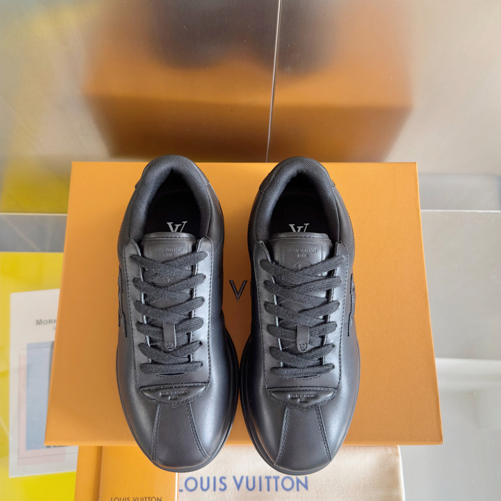 Black leather lace-up sneakers, front view pair with visible tongue logo