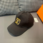 Black Louis Vuitton baseball cap with gold LV monogram and curved brim
