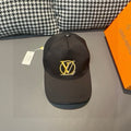 Black Louis Vuitton baseball cap with gold LV monogram on front, curved brim