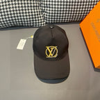 Black Louis Vuitton baseball cap with gold LV monogram on front, curved brim
