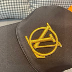 Gold LV monogram emblem on black Louis Vuitton baseball cap front