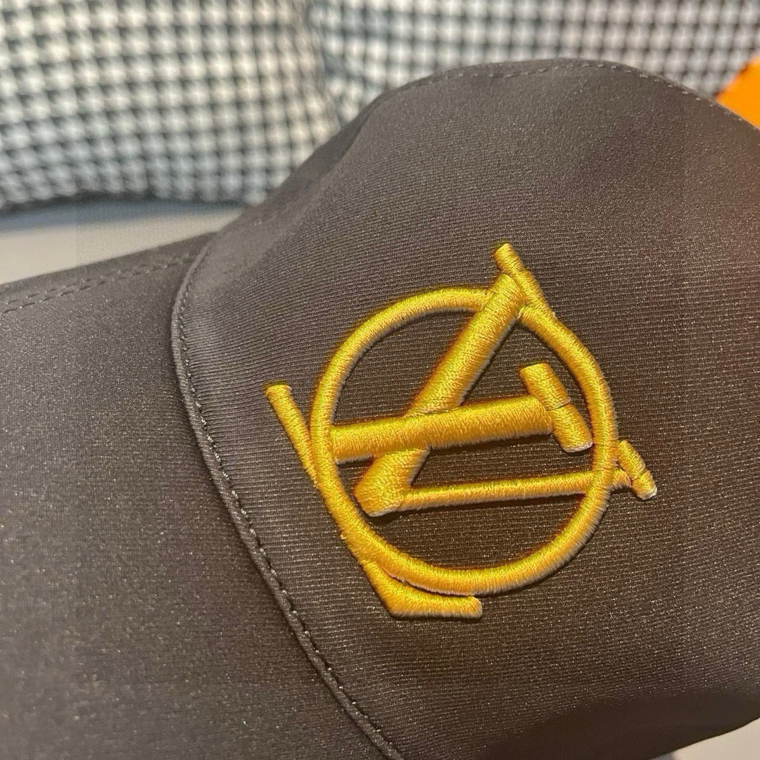 Gold LV monogram emblem on black Louis Vuitton baseball cap front