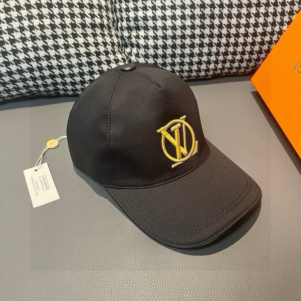 Black Louis Vuitton baseball cap with gold LV monogram on front panel