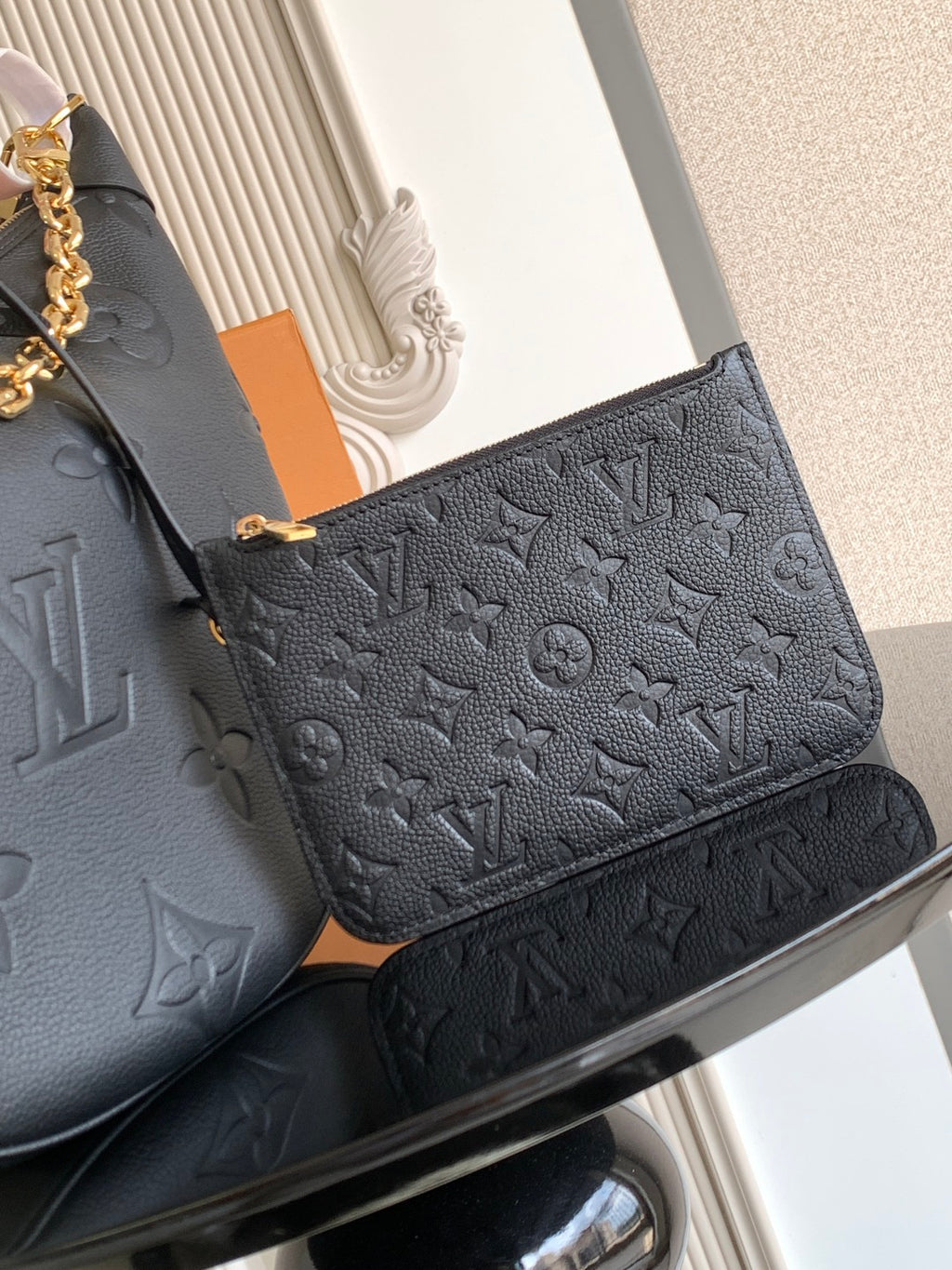 Louis Vuitton small flap bag in dark leather with embossed monogram pattern