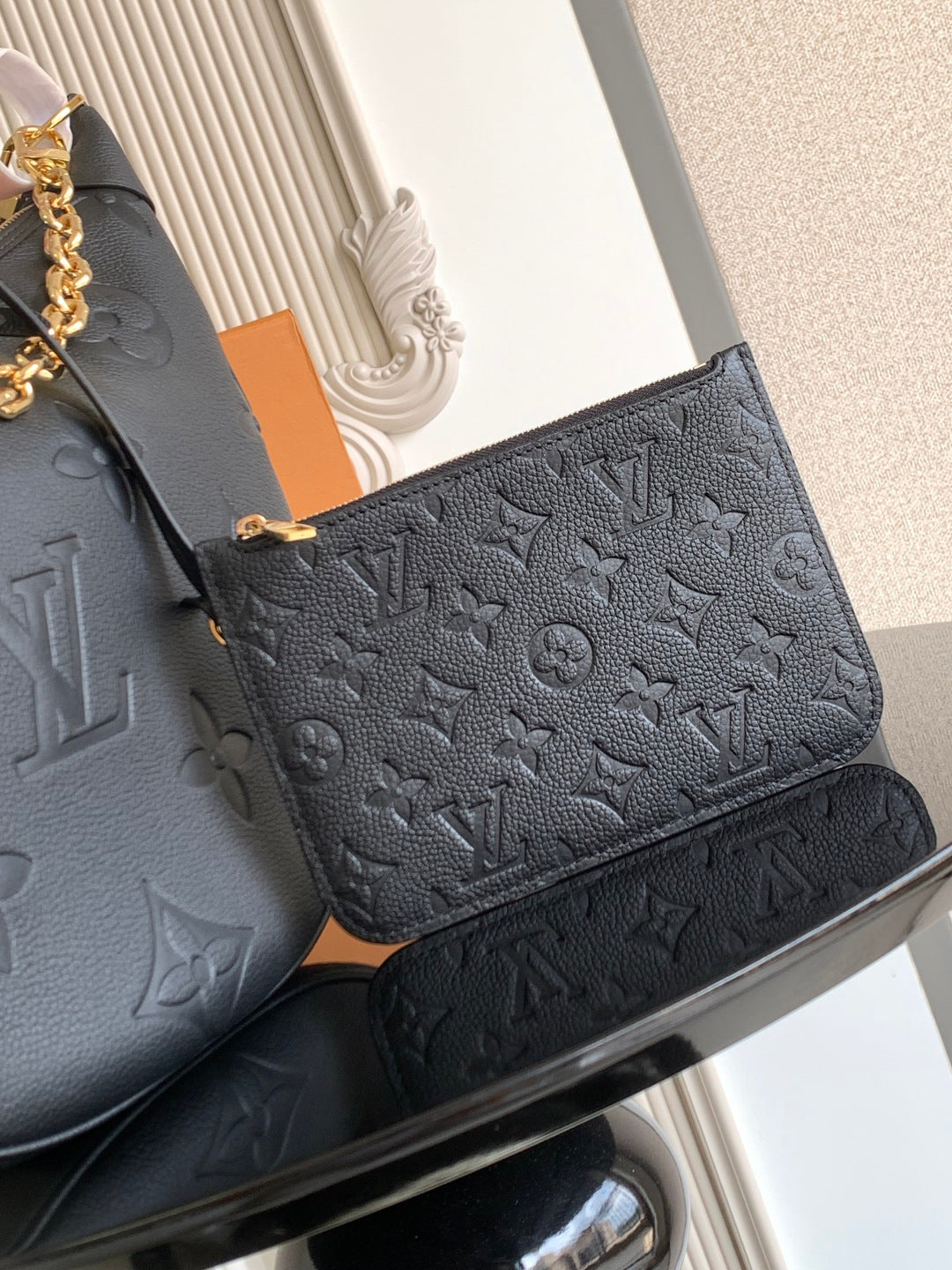 Louis Vuitton small flap bag in dark leather with embossed monogram pattern