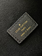 Louis Vuitton Paris embossed card tag on dark textured leather