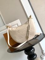 Louis Vuitton crossbody hobo bag in light beige with embossed monogram and front pocket