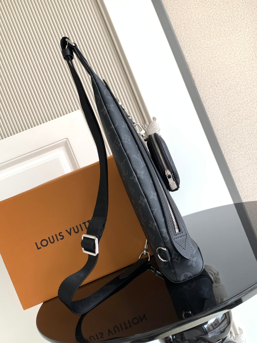 Louis Vuitton monogram crossbody bag side view with zipper pull and shoulder strap