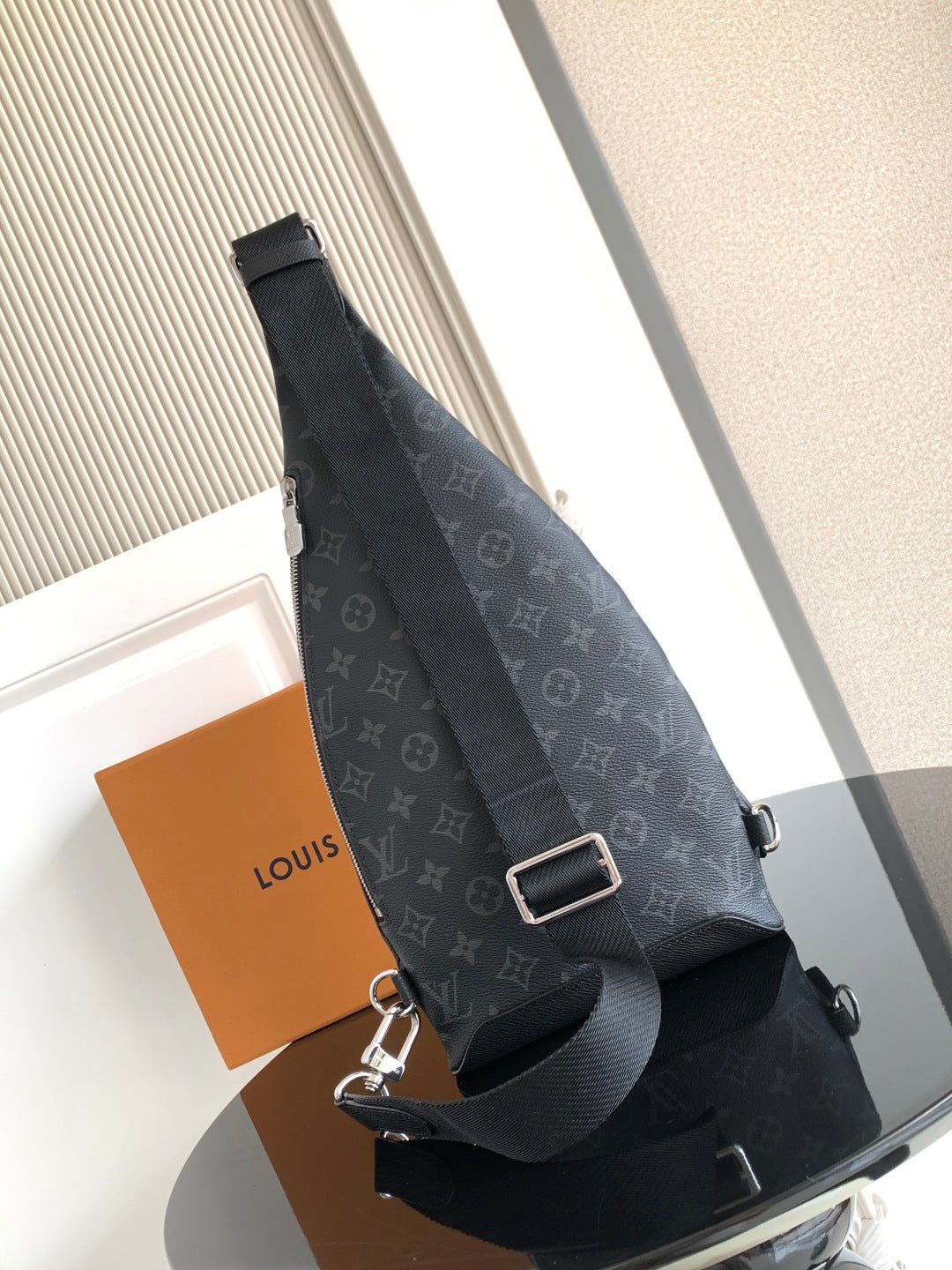 Louis Vuitton monogram crossbody bag with adjustable web strap and metal buckle