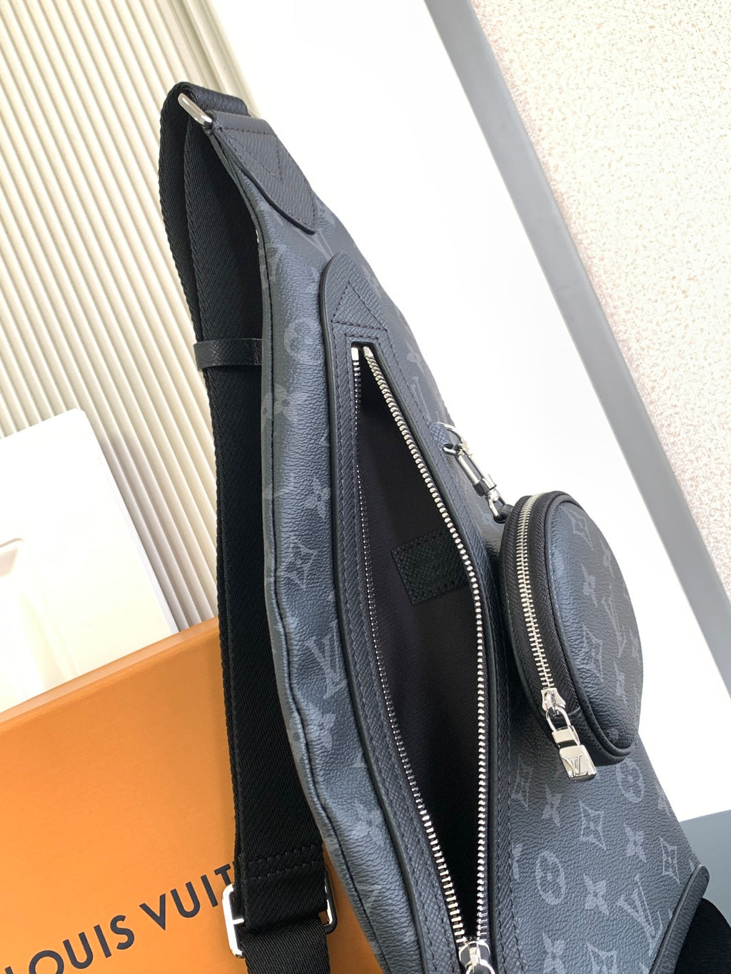 Louis Vuitton monogram crossbody bag with long zipper pocket and adjustable strap