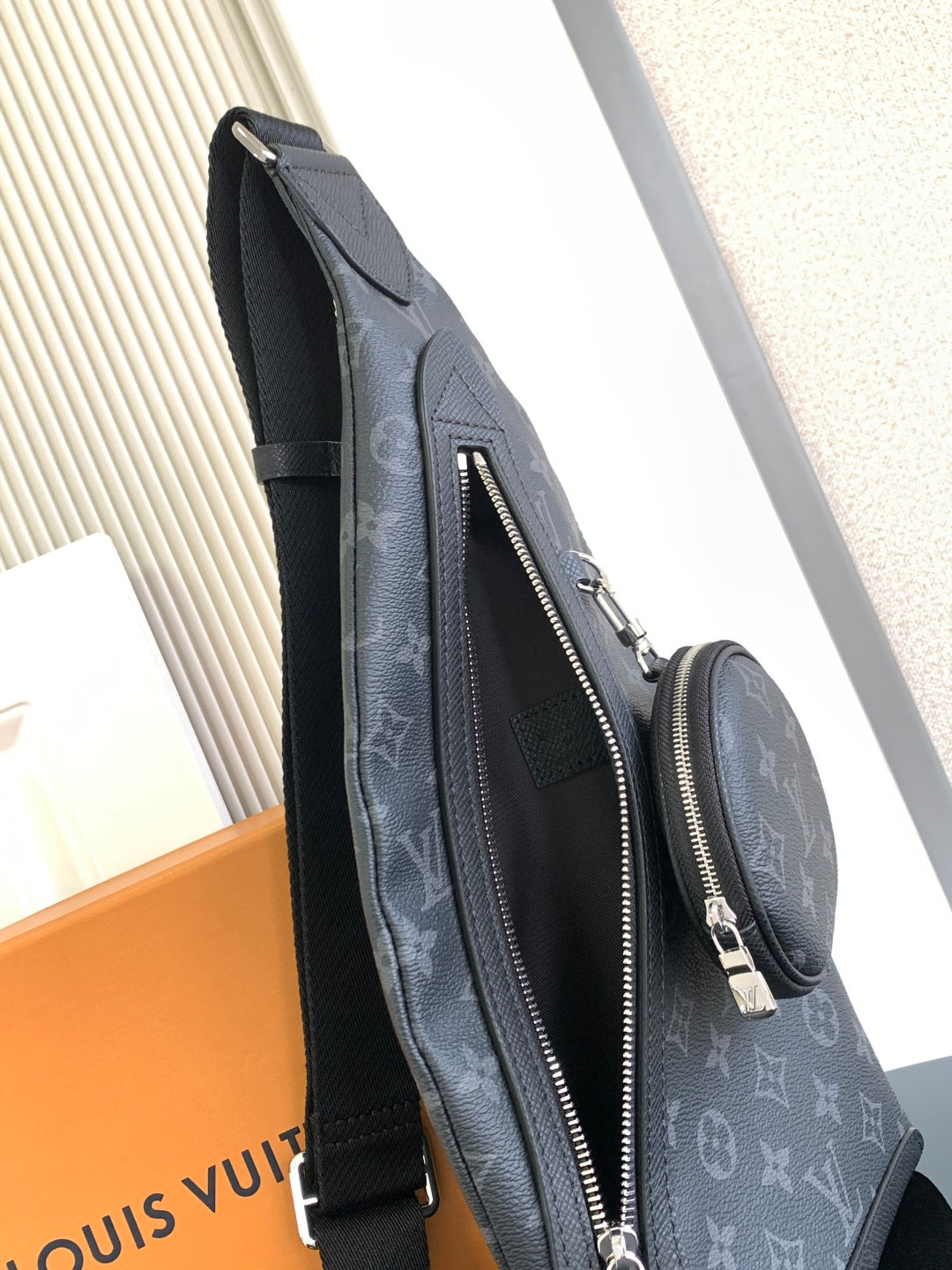 Louis Vuitton monogram crossbody bag with long zipper pocket and adjustable strap