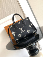 Louis Vuitton tote bag in dark navy monogram pattern with handles and shoulder strap