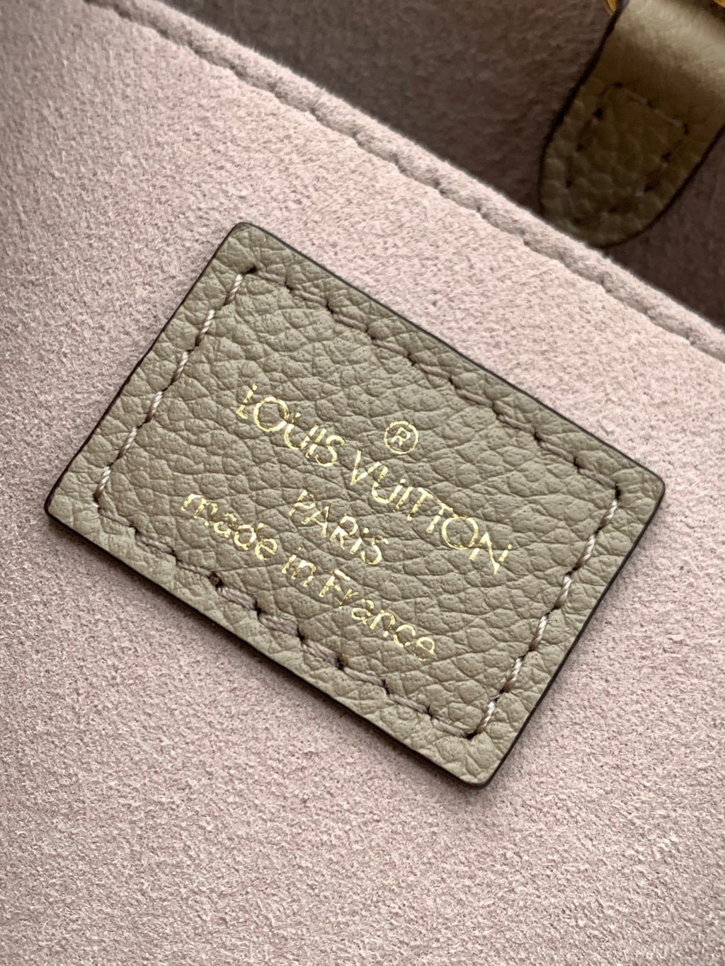 Louis Vuitton taupe interior label card with embossed brand and product text