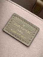 Louis Vuitton taupe interior label card with embossed brand and product text
