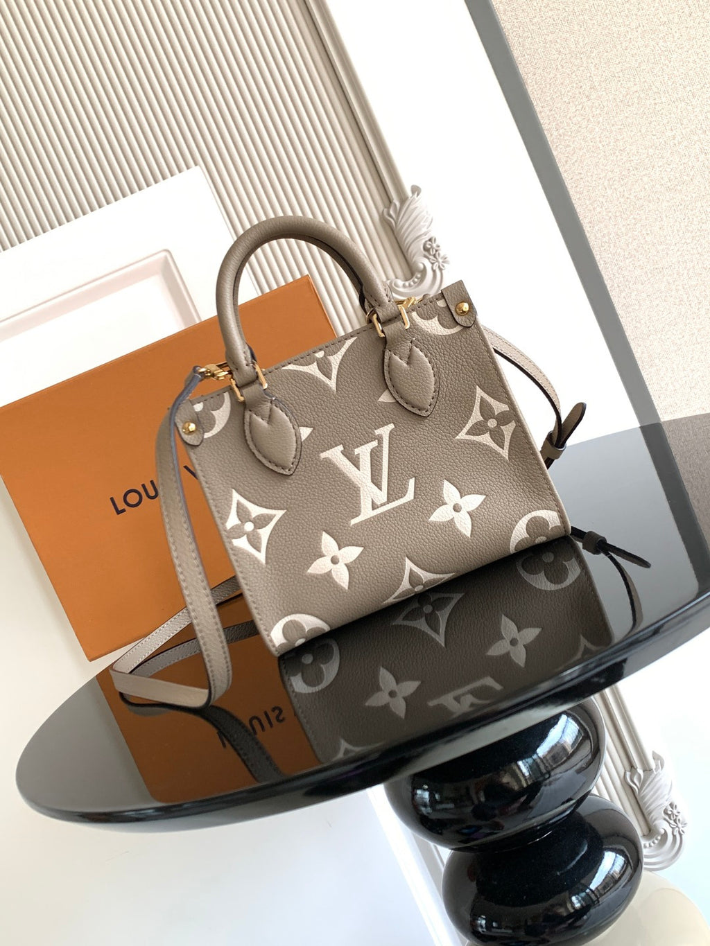 Louis Vuitton monogram handbag in taupe with leather handles and top zip closure