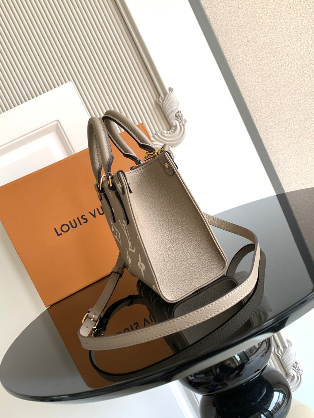 Louis Vuitton monogram handbag with taupe leather straps and gold-tone hardware