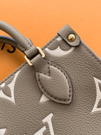 Close-up of Louis Vuitton taupe leather pocket with snap button and textured grain