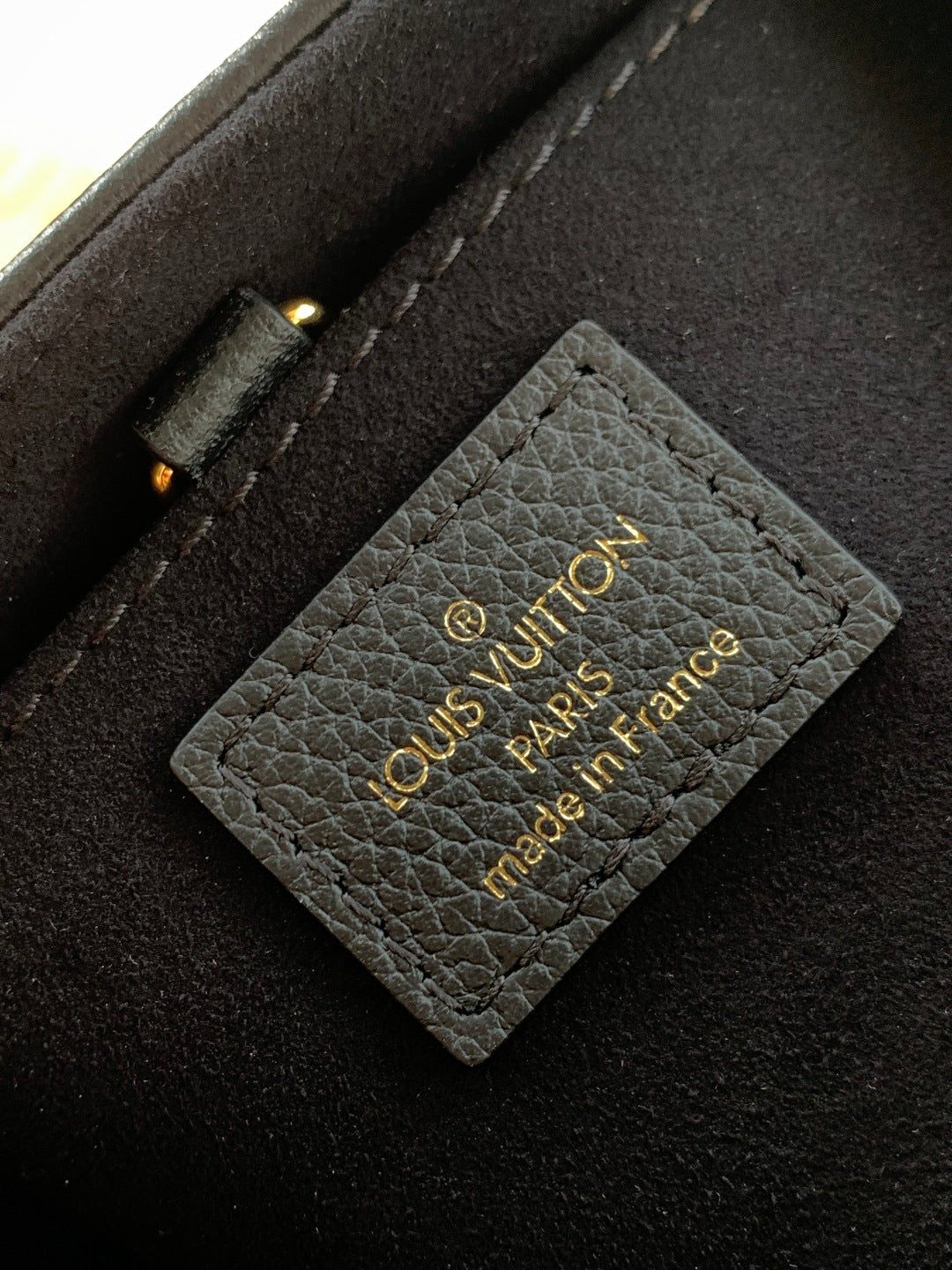 Black interior card slot with Louis Vuitton Paris France text label