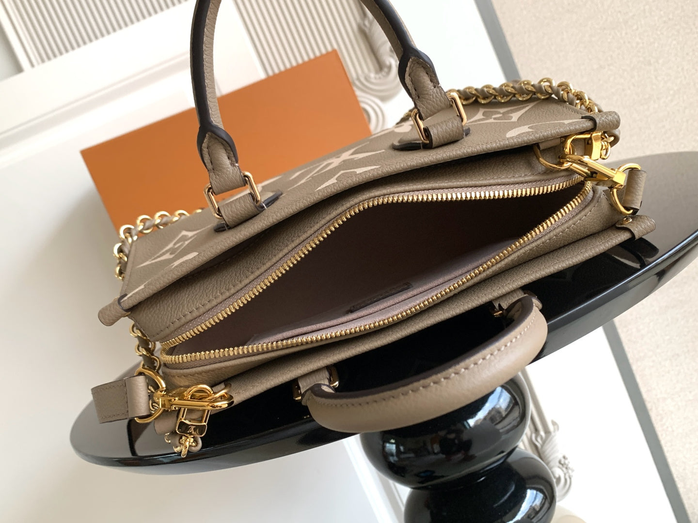 Monogram handbag in gray-brown with gold zipper and chain strap plus top handles