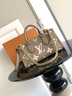 Louis Vuitton monogram tote handbag with gray-brown canvas, top handles and chain strap