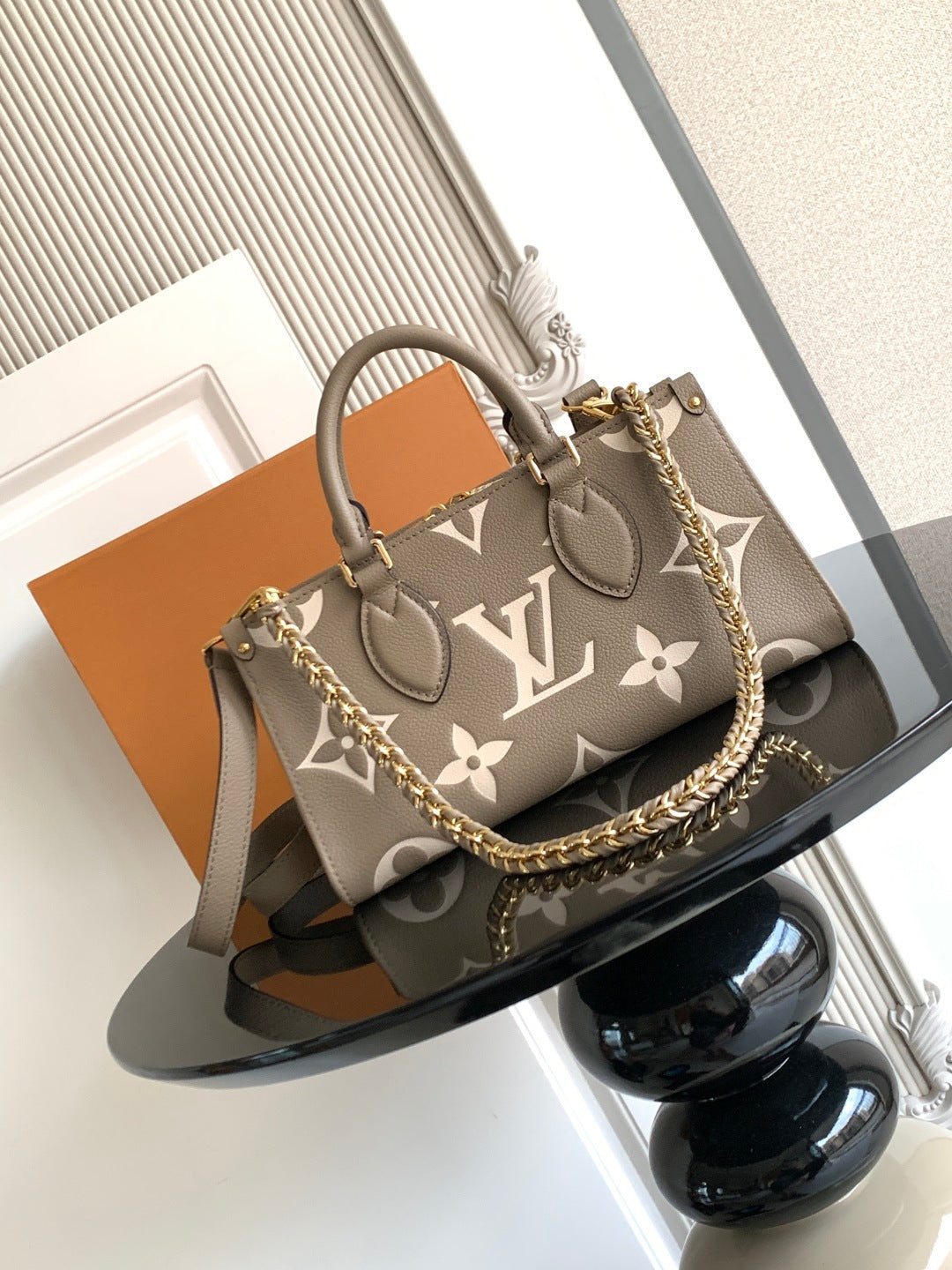 Louis Vuitton monogram tote handbag with gray-brown canvas, top handles and chain strap